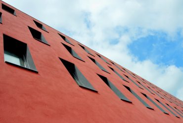 low-angle photography of red concrete building